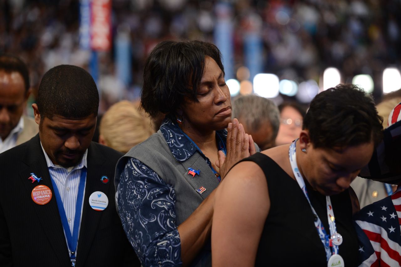 Supporters pray during an invocation on Thursday.