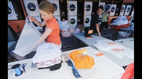 Worker Holly Rochelle sorts a resident's laundry, washed for free at the Tide Loads of Hope mobile laundromat set up for those affected by Isaac, on Thursday in LaPlace.