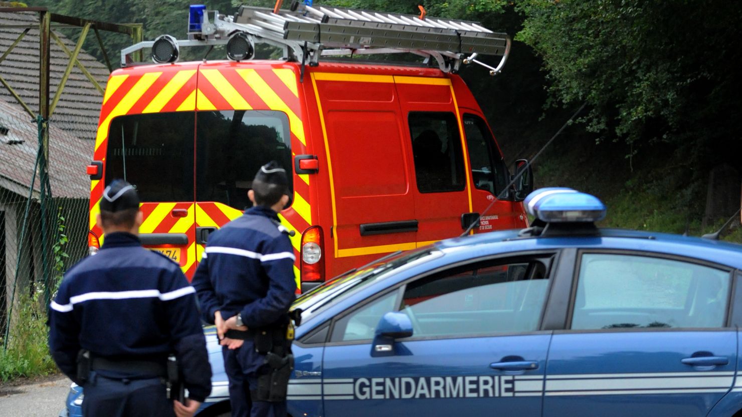 French police stand guard near the French Alpine village of Chevaline after the shootings.