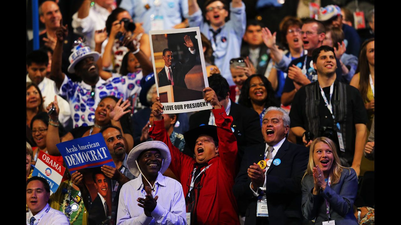 Gus Mansour holds up a poster of President Barack Obama on Thursday.
