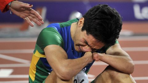 Brazil's Yohansson Nascimento breaks down on the finish line after finishing last in the men's 100-meter T46 final Thursday.
