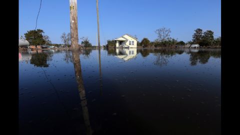 Floodwaters linger Thursday in Braithwaite, Louisiana.