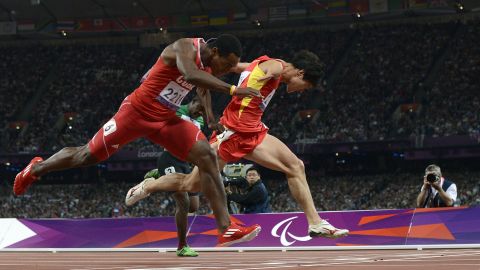 China's Zhao Xu, right, dips for the finish line, just ahead of Cuba's Raciel Gonzalez Isidoria to win the men's 100-meter T46 final on Thursday, September 6.