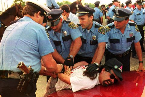 <strong>1992:</strong> Police officers at the 1992 Republican National Convention in Houston arrest a demonstrator from La Resistencia, an organization protesting acts of violence against immigrants and the deportation of illegal immigrants. The demonstrators failed to adhere to rules keeping them inside a 35-acre protest site across from the Astrodome, where convention delegates gathered.