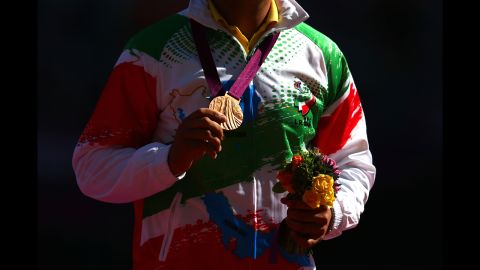 Bronze medalist Farzad Sepahvand of Iran poses Friday during the medal ceremony for the men's discus throw F44 final.