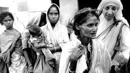 Mother Teresa, head of the Sisters of Charity, works with some of the lepers in Calcutta on December 7, 1971.
