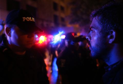 <strong>2012:</strong> In Charlotte, a police officer faces off with a protester blocking the road.