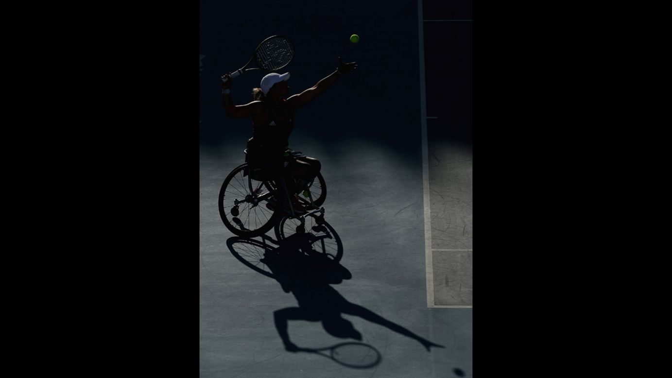 A shadow of Lucy Shuker serving with partner (out of frame) Jordanne Whiley of Great Britain to Sakhorn Khanthasit and Ratana Techamaneewat of Thailand in the women's doubles bronze medal match for wheelchair tennis on Friday.