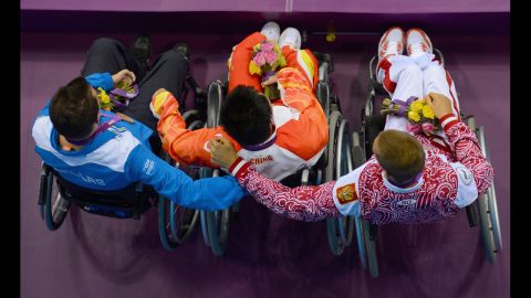 Silver medallist Dmitrii Kokarev of Russia, gold medallist Yang Yang of China and bronze medallist Arisdteidis Makrodimitris of Greece pose on the podium during the medal ceremony for the men's 50m freestyle - S2 final on Friday.