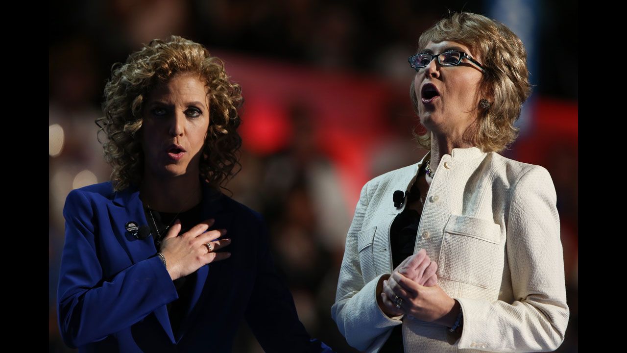 Former U.S. Rep. Gabrielle Giffords, right, recites the Pledge of Allegiance on stage with Democratic National Committee Chair Debbie Wasserman Schultz on Thursday.
