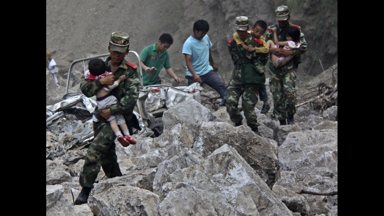 Soldiers carry children to safe ground after two earthquakes hit Zhaotong, Yunnan province, on Friday, September 7. 