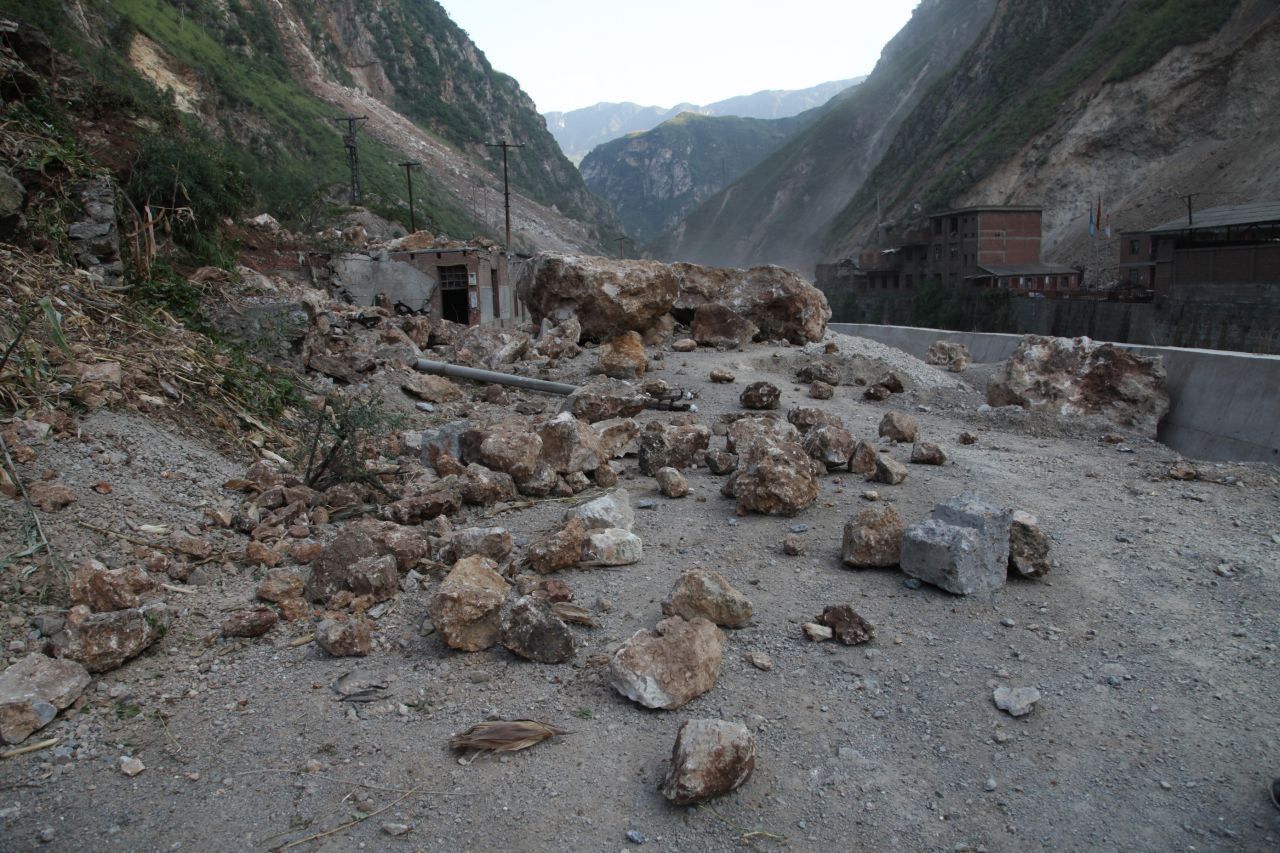 Fallen rocks block a road in Yiliang.
