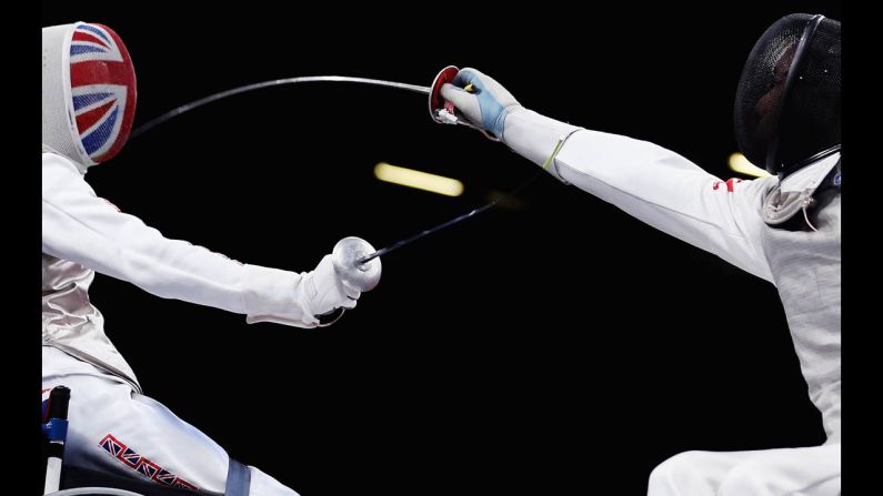 Simon Wilson, left, of Great Britain competes against Tang Tat Wong of Hong Kong during the men's open wheelchair fencing quarter-final match on Saturday.