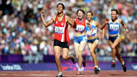 Neda Bahi of Tunisia crosses the line to win gold ahead of silver medalist Viktoriya Kravchenko of Ukraine, No. 1389, and bronze medalist Evgeniya Trushnikova of Russia, No. 1337, in the women's 400-meter T37 final on Saturday.