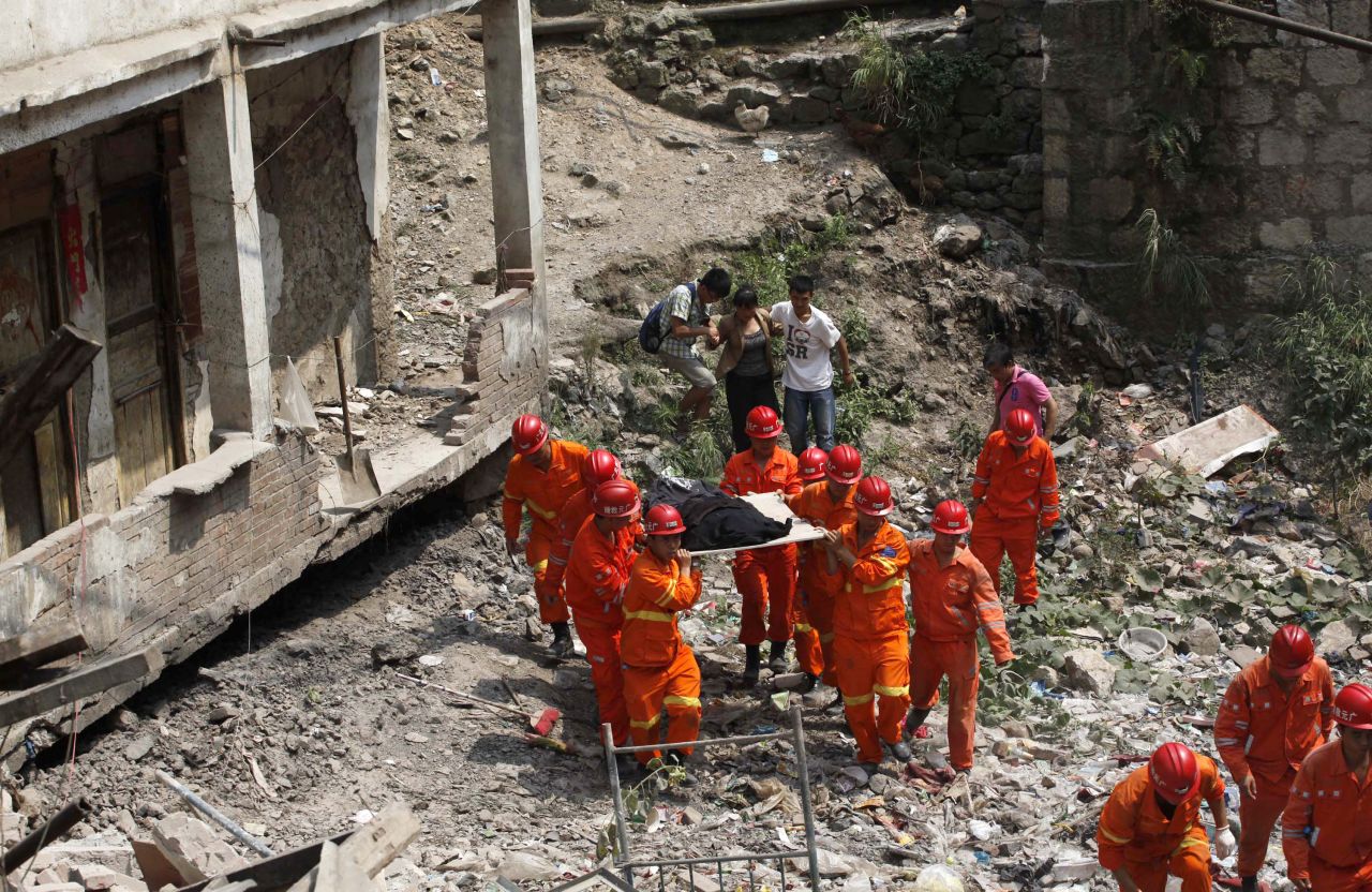 Rescuers remove a body of a victim on Saturday. The southwestern region of China is prone to earthquakes. In May 2008, a magnitude 7.9 quake in Sichuan province caused widespread devastation, killing at least 69,000 people.