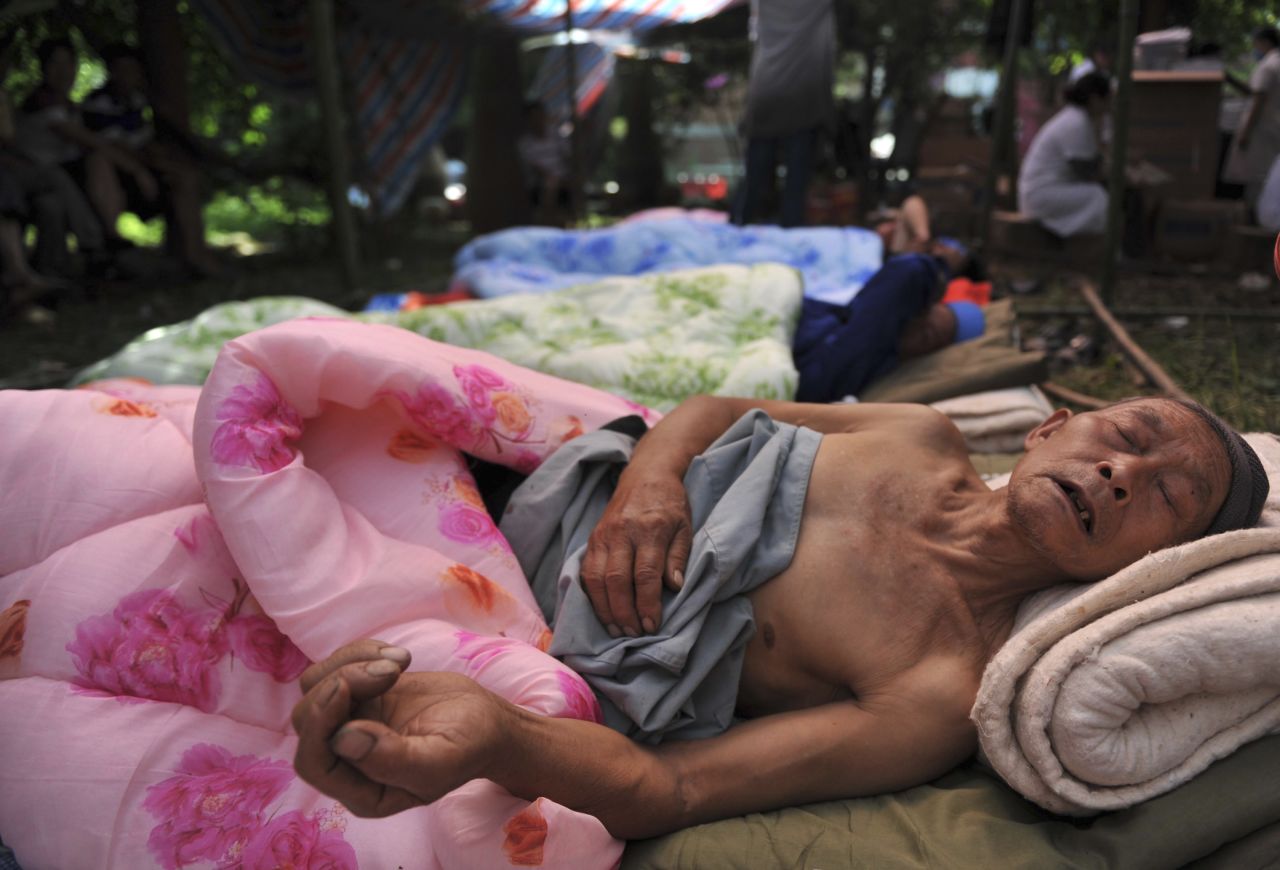 A injured person lies in bed at a temporary hospital on Saturday.