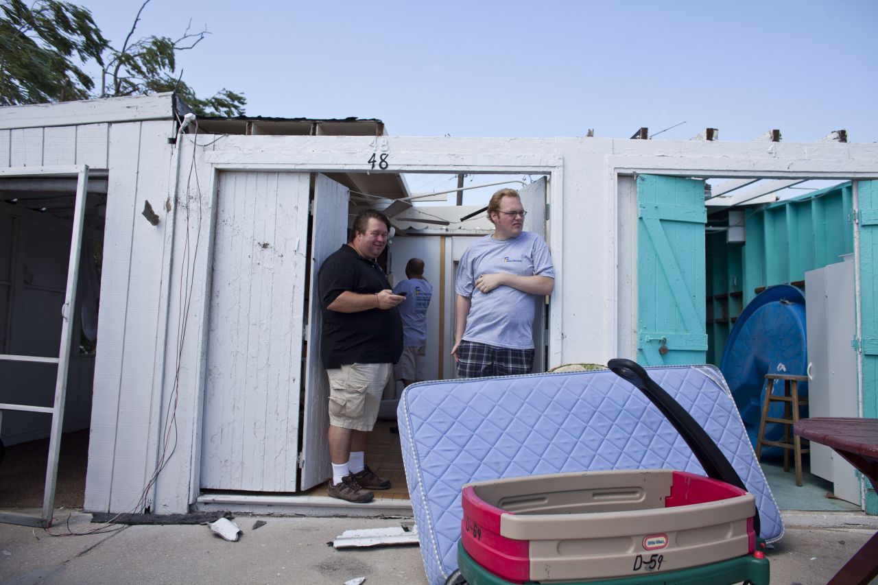  People inspect the damage in their rental cabanas.