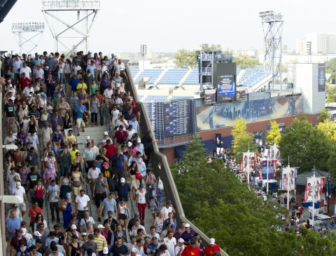 Spectators evacuate the Arthur Ashe Stadium during a semifinal match at the U.S. Open due to severe weather in the area. 
