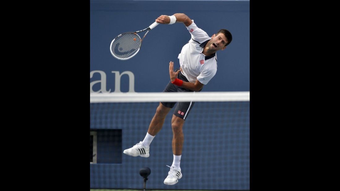 Djokovic comes down on the ball while playing Ferrer on Saturday.