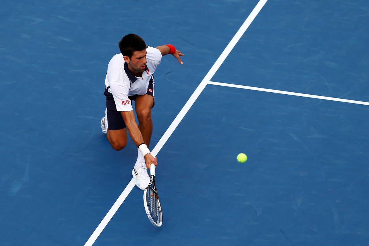 Djokovic returns a shot against against Ferrer during their men's singles semifinal match of the 2012 US Open on Saturday, September 8.  The match was stopped in the middle of the first set due to approaching severe weather and resumed on Sunday.