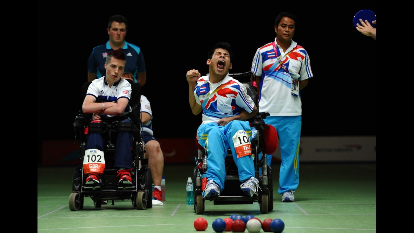 Thailand's Pattaya Tadtong, right, celebrates beating Britain's David Smith, left, in the final of the boccia individual BC1 competition on Saturday.