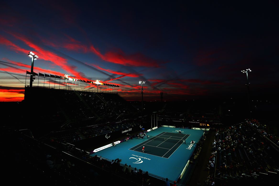 The sun sets as Shingo Kunieda of Japan, front left, plays against Stephane Houdet of France in the men's wheelchair tennis gold medal match on Saturday.
