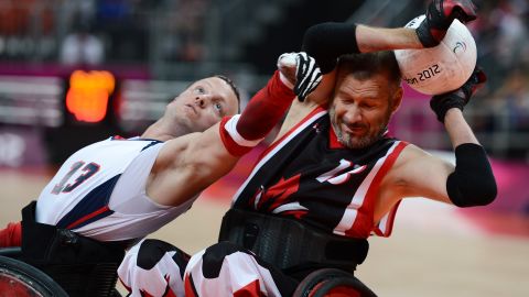 No. 13 Derrick Helton of the United States attempts to get the ball from No. 13 Jared Funk of Canada during Saturday's mixed wheelchair rugby semifinal match between the U.S. and Canada.