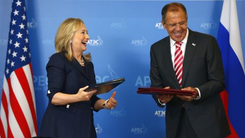 Hillary Clinton and Sergei Lavrov exchange documents after signing a memorandum of understanding on Antarctica.