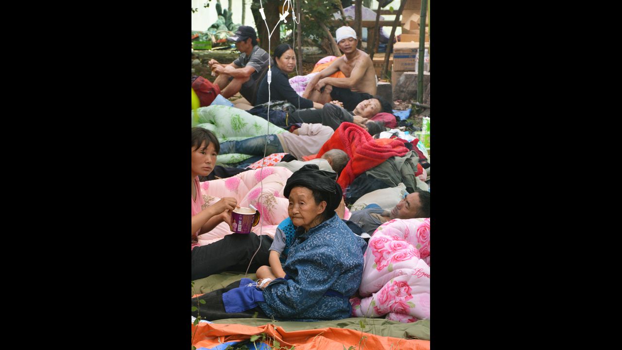 Injured villagers receive medical treatment at an evacuation center in Yiliang on Sunday.