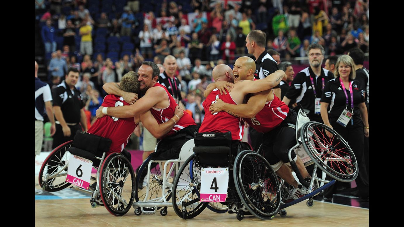 Canadian teammates celebrate after defeating Australia to win the gold medal wheelchair basketball competition Sunday.