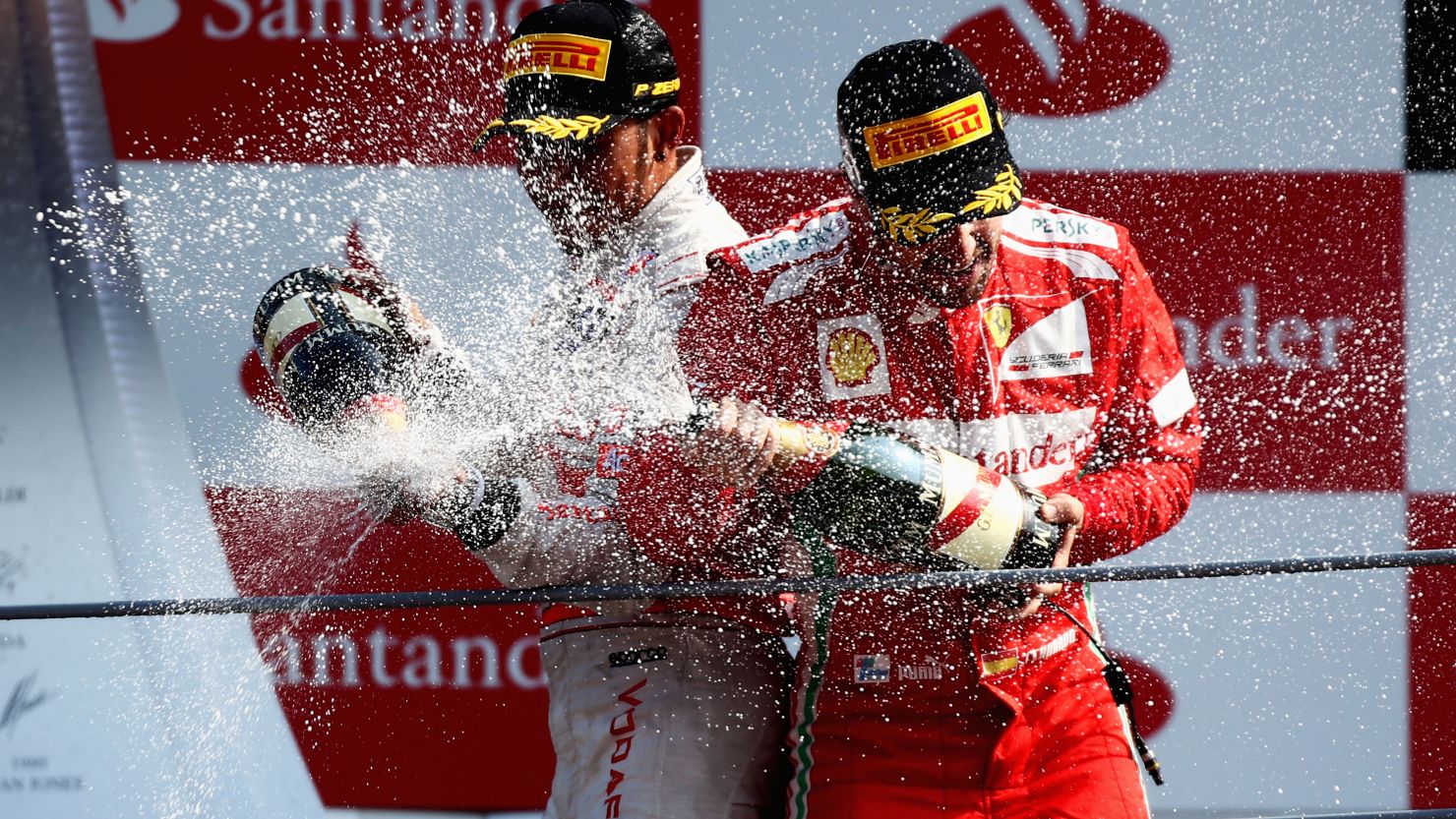 Race winner Lewis Hamilton (L) and championship leader Fernando Alonso celebrate on the podium at Monza.