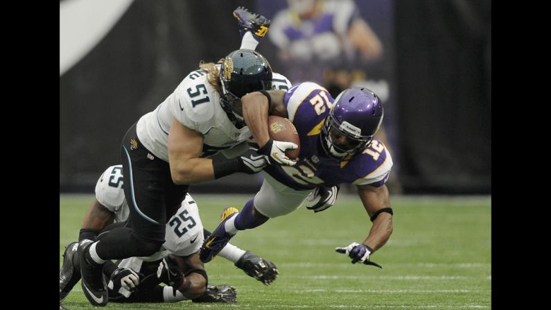 No. 51 Paul Posluszny of the Jaguars brings down No. 12 Percy Harvin of the Vikings during the first quarter of the season opener in Minneapolis on Sunday.