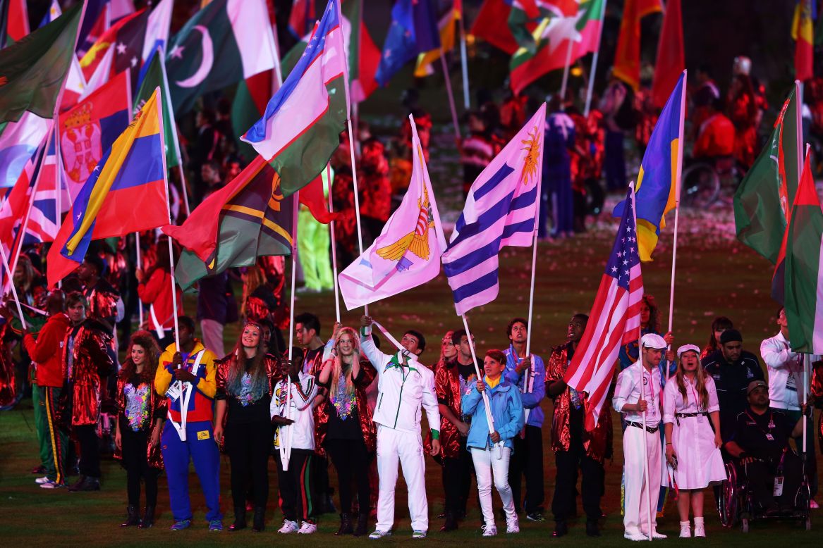 Flag bearers carry their national flags during the closing ceremony.