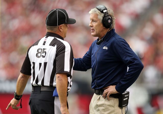 Head coach Pete Carroll of the Seahawks talks with side judge Mike Riley on Sunday.