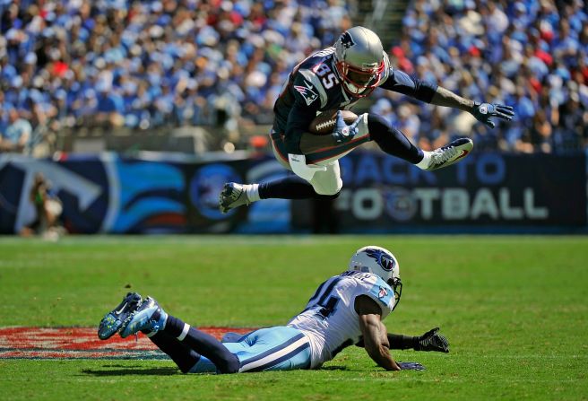 No. 85 Brandon Lloyd of the New England Patriots jumps over No. 24 Coty Sensabaugh of the Tennessee Titans on Sunday.