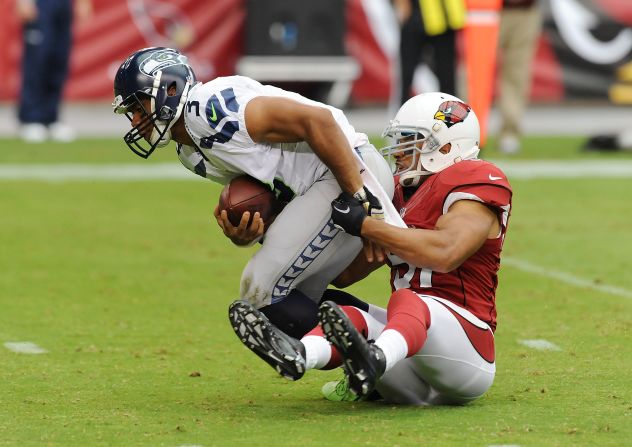 No. 3 Russell Wilson of the Seahawks is sacked by No. 51 Paris Lenon of the Cardinals on Sunday.