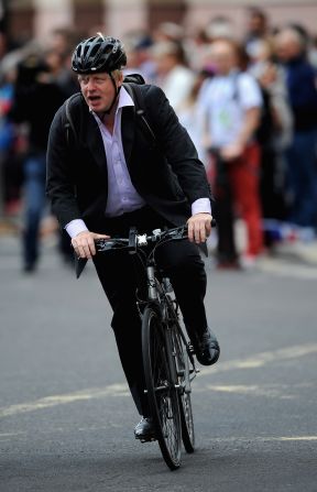 Mayor of London Boris Johnson cycles along the parade route ahead of the arrival of the Team GB and Paralympic GB athletes. 