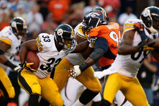 No. 33 running back Isaac Redman of the Pittsburgh Steelers holds off No. 94 linebacker Lawrence Timmons of the Denver Broncos on Sunday.