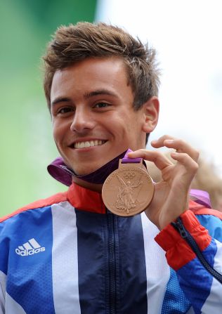 Daley shows off his Olympics bronze medal to the crowd.