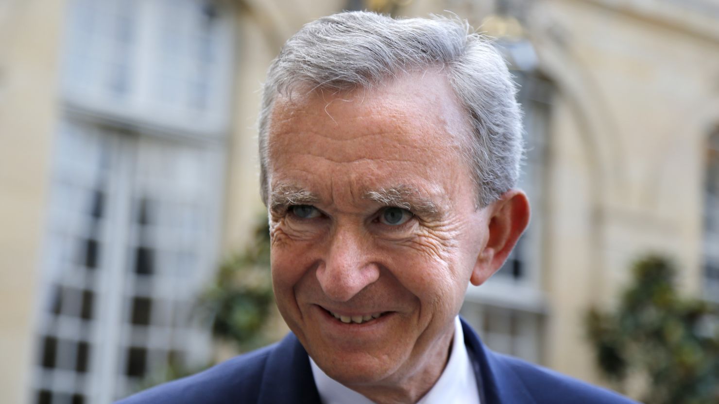 Bernard Arnault, France's richest man, says he will remain a tax resident of France despite a new 75% tax rate.