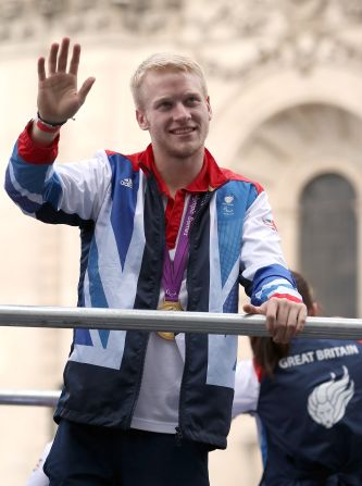 100m Paralympic Gold medalist Jonnie Peacock waves to the crowd during the London 2012 Victory Parade.