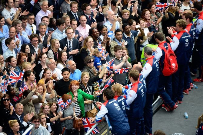 Members of Team GB greet spectators as the Victory Parade passes along Fleet Street, London. 
