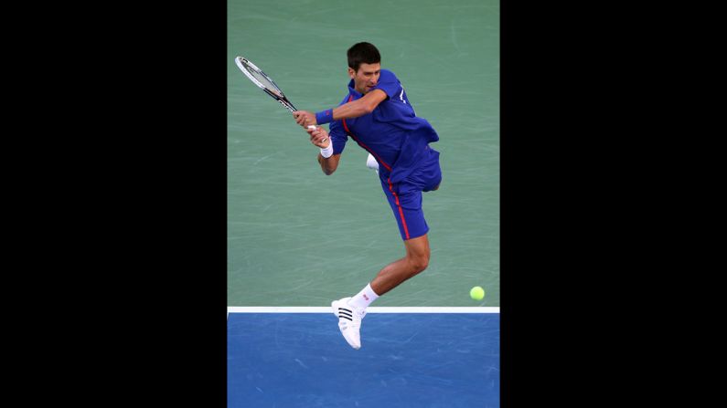 Novak Djokovic returns a shot to Andy Murray on Monday.
