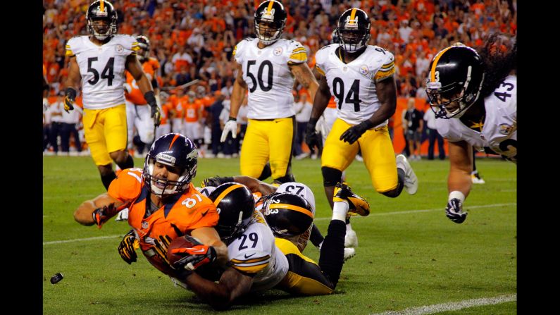 No. 87 Eric Decker of the Denver Broncos makes a 17-yard reception as No. 29 Ryan Mundy and No. 23 Keenan Lewis of the Pittsburgh Steelers make the tackle. The Broncos defeated the Steelers 31-19 on Sunday, September 9.