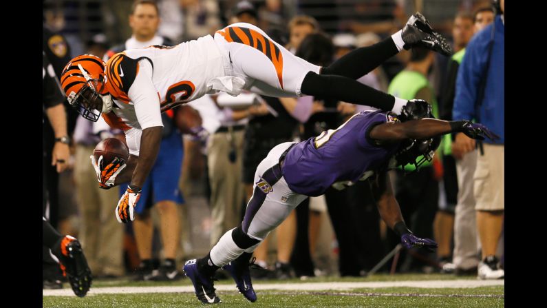 Wide receiver Armon Binns of the Cincinnati Bengals is tackled by cornerback Lardarius Webb of the Baltimore Ravens after catching a pass on Monday.