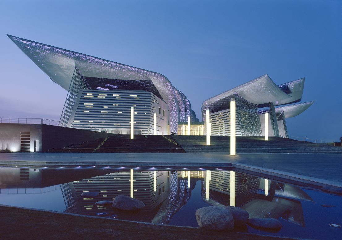 Built on the man-made peninsula of Taihi Lake in China, the Wuxi Grand Theatre was designed to have the appearance of a sculpture rising from the sea. Adding a touch of drama, the steel wings are dotted with thousands of LED lights that change color according to the character of the performances.<br /><em>Designed by: PES-Architects, Finland</em>
