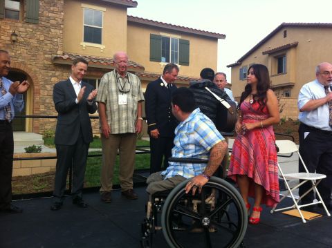Dominguez, with his wife Alexis, is cheered by Temecula Mayor Chuck Washington (from left), actor Gary Sinise, Ned Wallace, Ret. FDNY Battalion Chief John Carroll, and Jim Shubert during the presentation of his new 'smart' home on September 11, 2012.