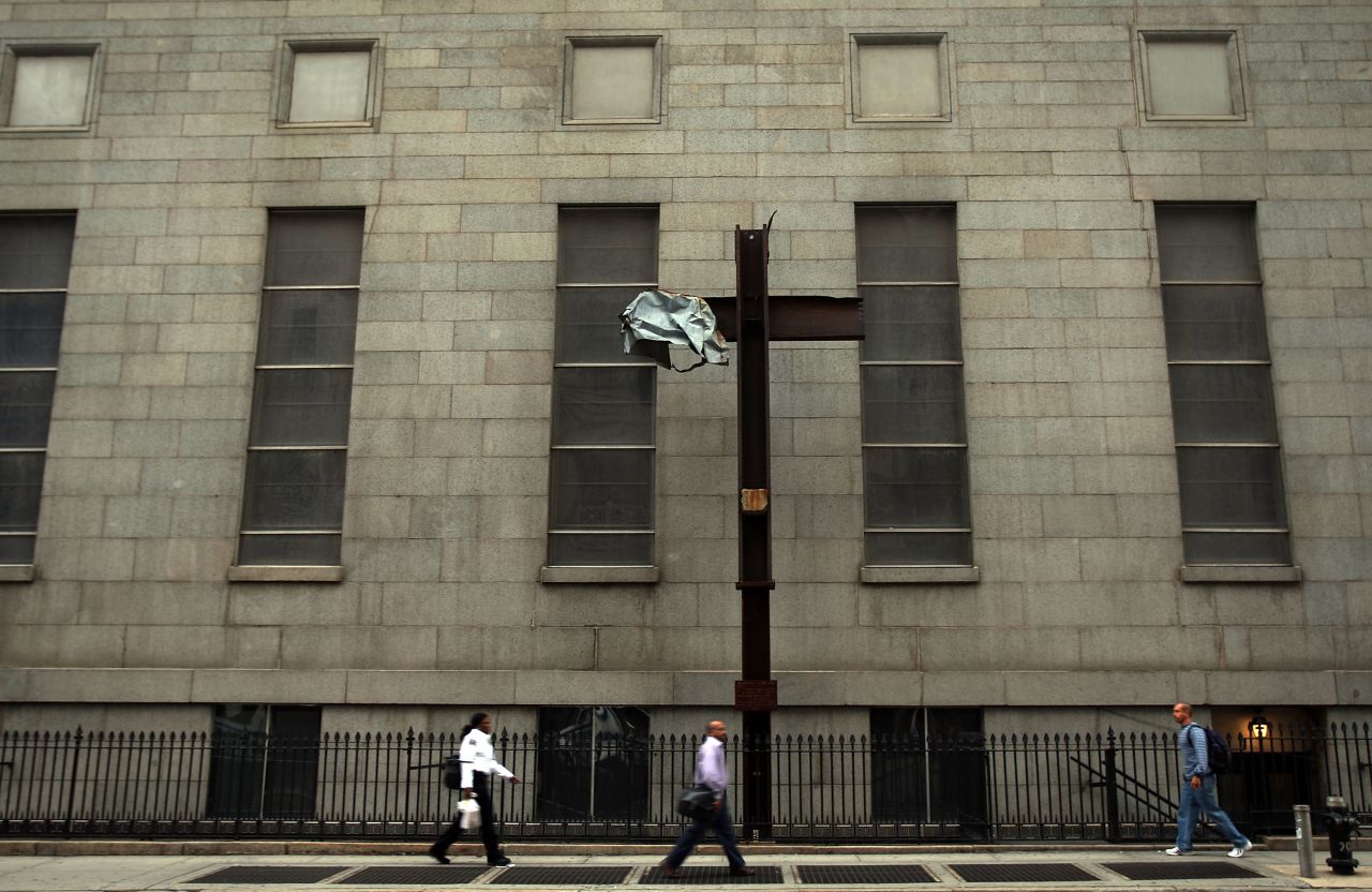 Pedestrians walk by the cross where it was mounted on Church Street in Lower Manhattan on September 11, 2008.