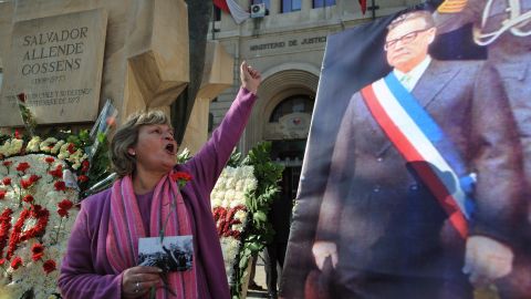 A woman shouts slogans during the commemoration of Allende's 100th birthday anniversary in Santiago on June 26, 2008. 