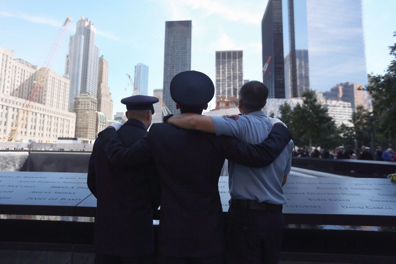 Fire fighters pay their respects at the 9/11 Memorial during ceremonies on Tuesday.